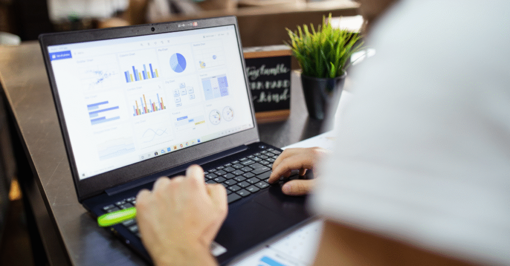 laptop on desk showing graphs